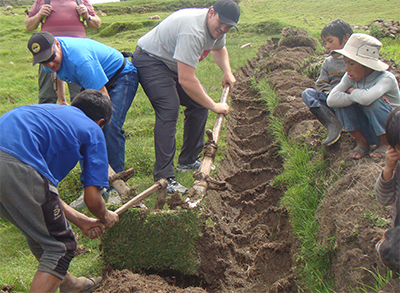 Tilling a field in Casa Ccunca, Peru